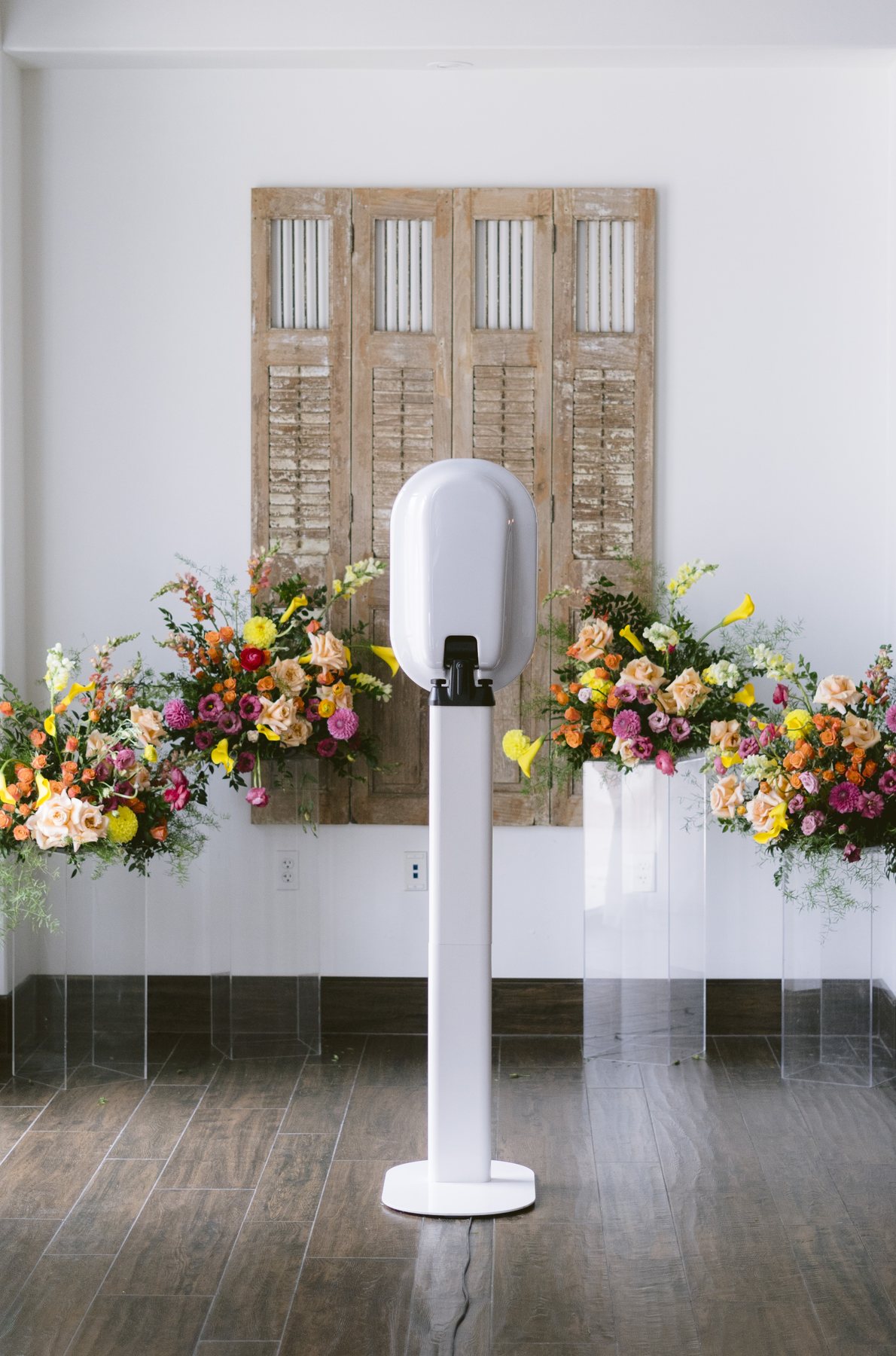 A June Light photo booth set up in front of carved wood doors before guests arrive
