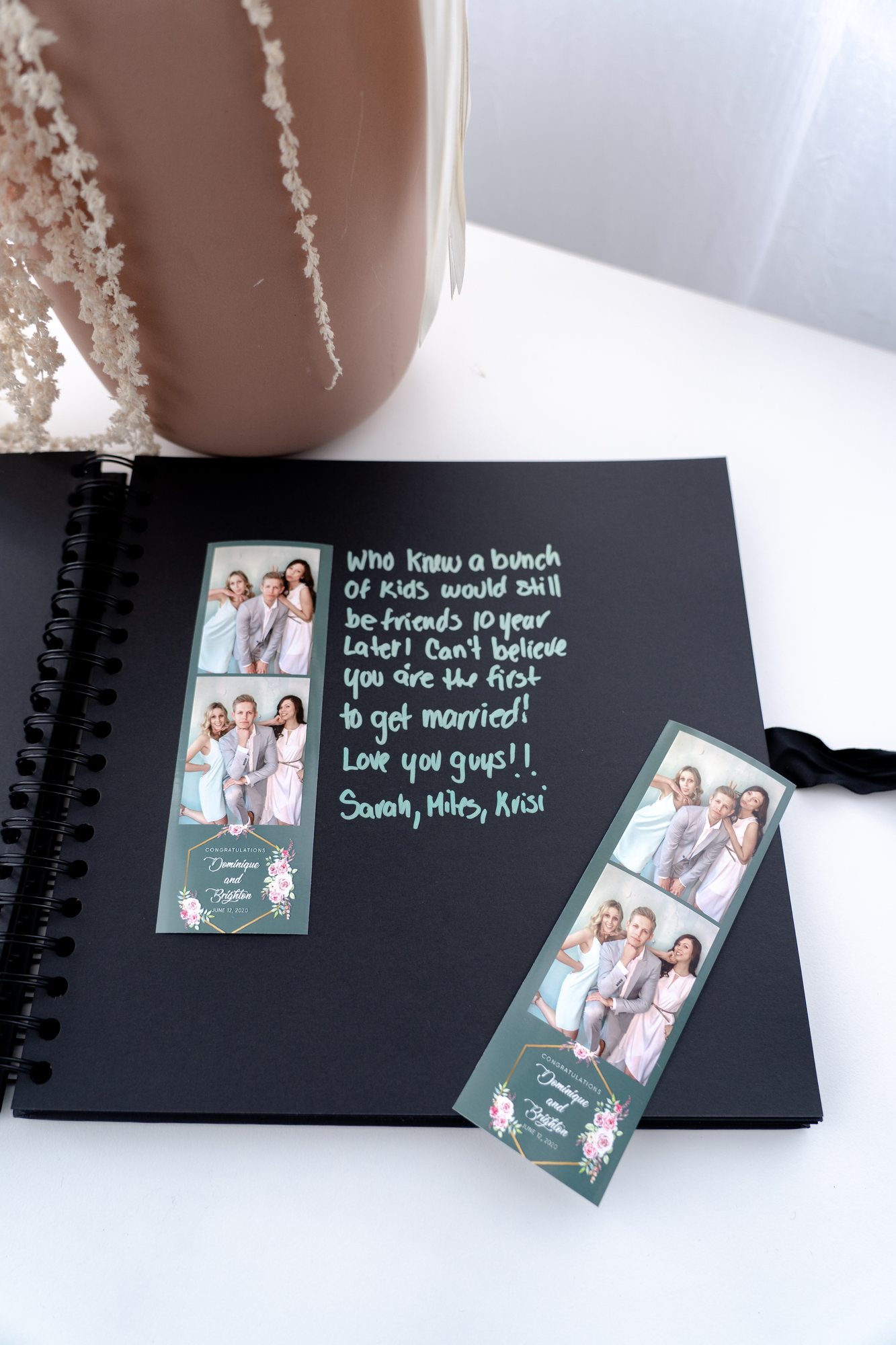 A keepsake book holding printed photo strips from the event