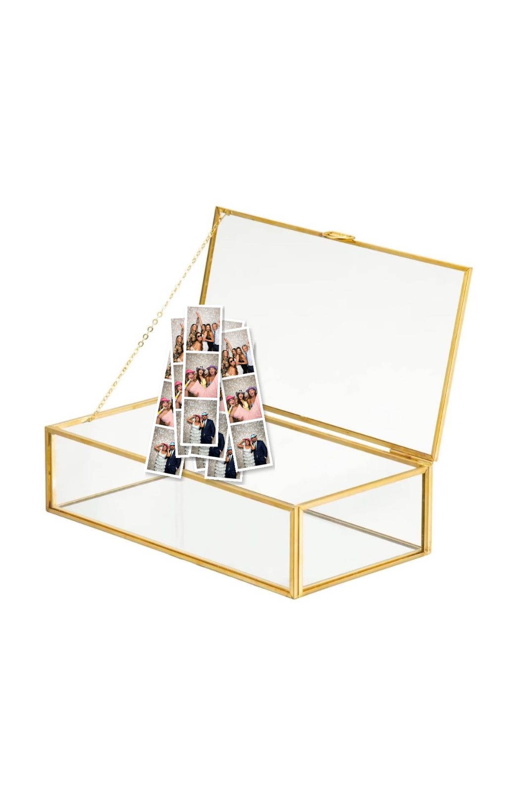 Open gold-trimmed glass keepsake box holding a stack of photo booth strips